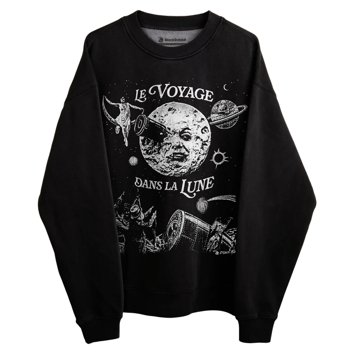 Black crewneck sweatshirt with ’le voyage dans la lune’ design featuring a moon, planets and space-themed elements.