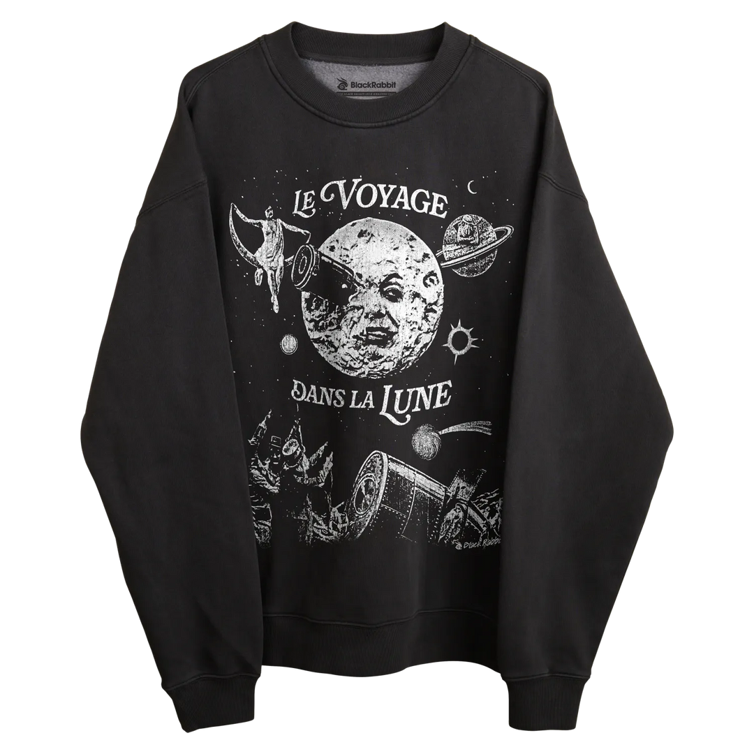 Black crewneck sweatshirt with ’le voyage dans la lune’ design featuring a moon, planets and space-themed elements.