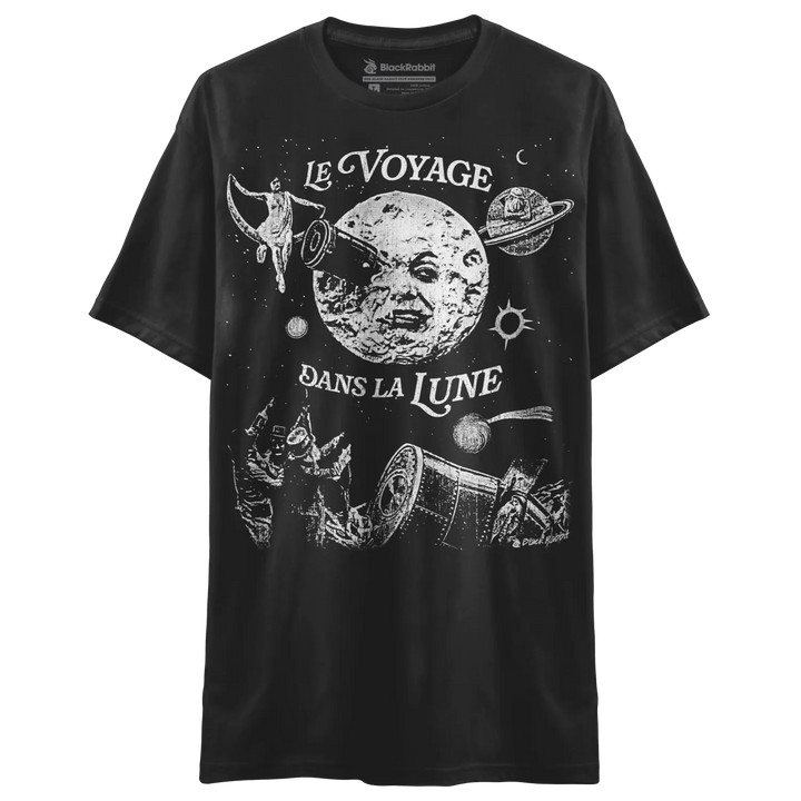 A black short-sleeved t-shirt with a white graphic of a moon with a face and celestial imagery, inspired by ’Le Voyage Dans La Lune.’