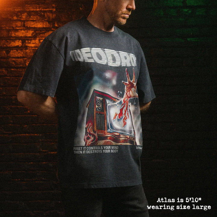 Male model wearing stone wash heavy tee with videodrome graphic 