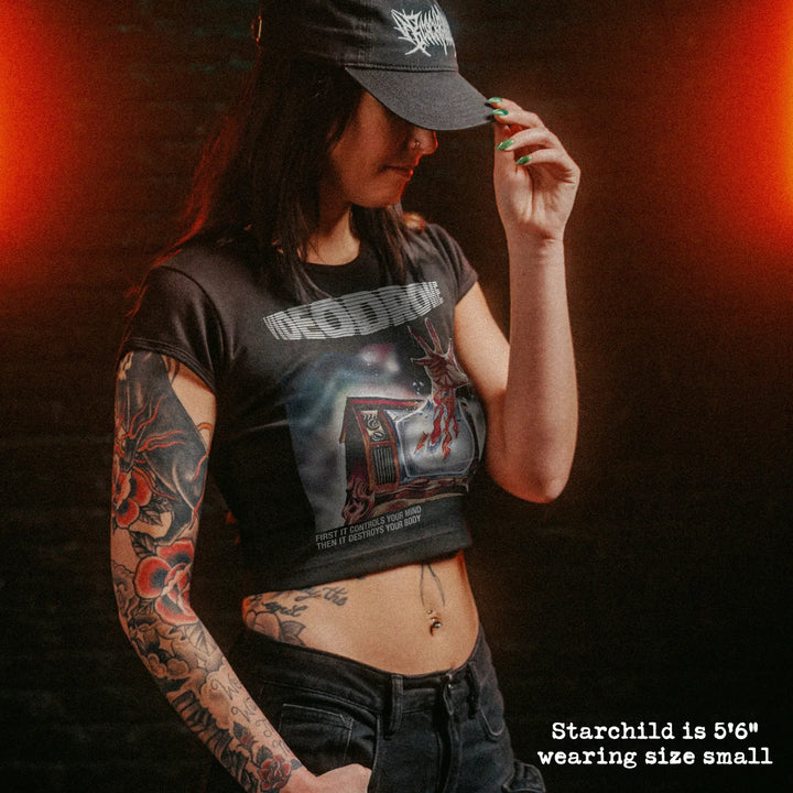 Female model wearing cropped baby tee with videodrome graphic
