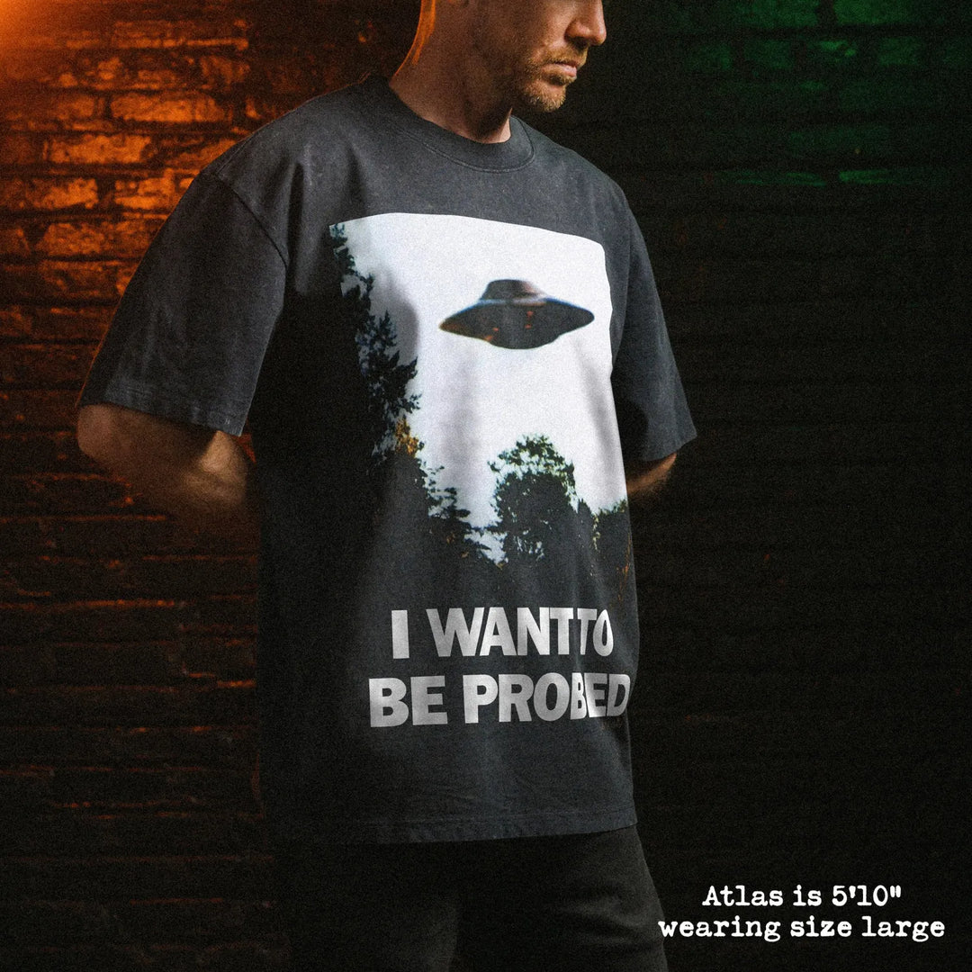 Male model wearing stone wash heavy tee with I want to be probed graphic 