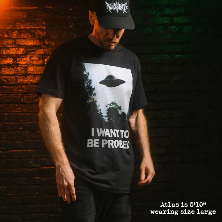 Male model wear soft premium tee with I want to be probed graphic

