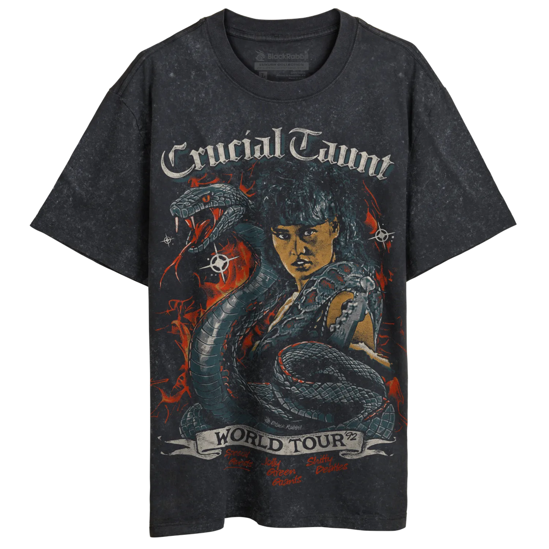Washed black graphic t-shirt featuring a fierce woman with a snake, ’Crucial Taunt World Tour ’92’’ text.