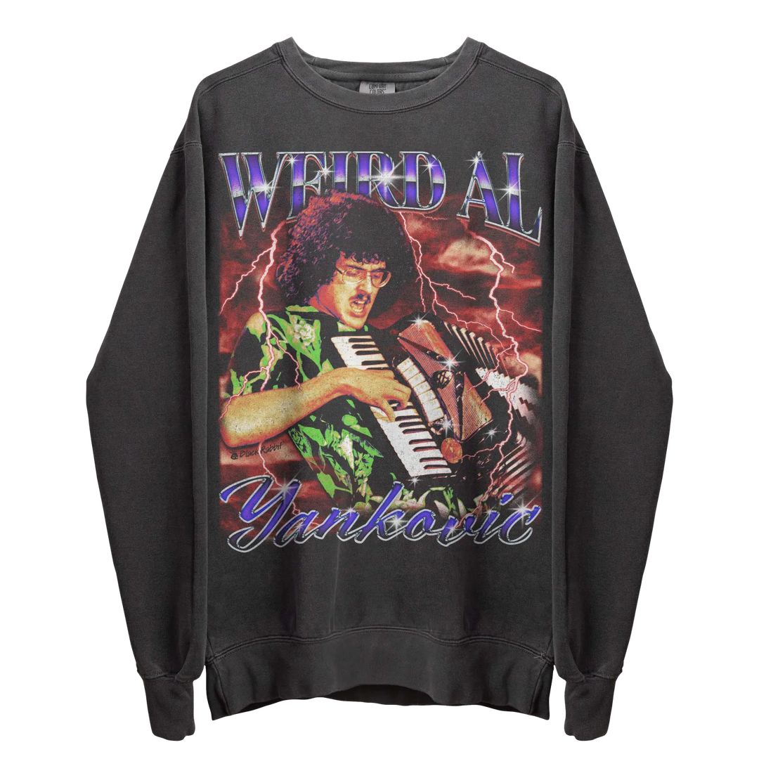 A dark gray long-sleeved sweatshirt with a graphic of ’Weird Al’ Yankovic playing an accordion, surrounded by lightning, and his name ’WEIRD AL YANKOVIC’ in stylized text.