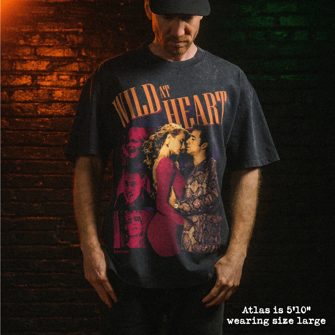 Male model wearing heavy stone washed tee with wild at heart graphic. 