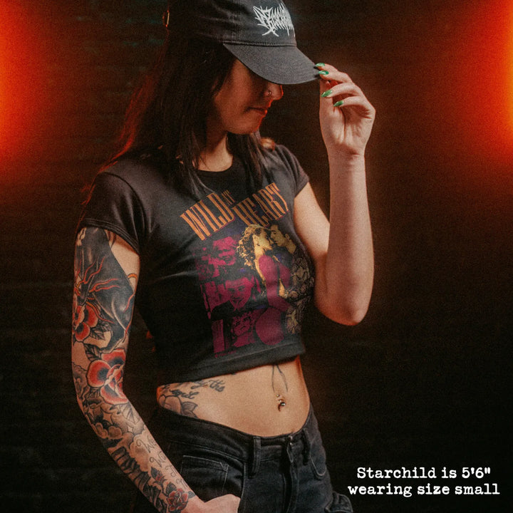 Female model wearing cropped baby tee with wild at heart graphic

