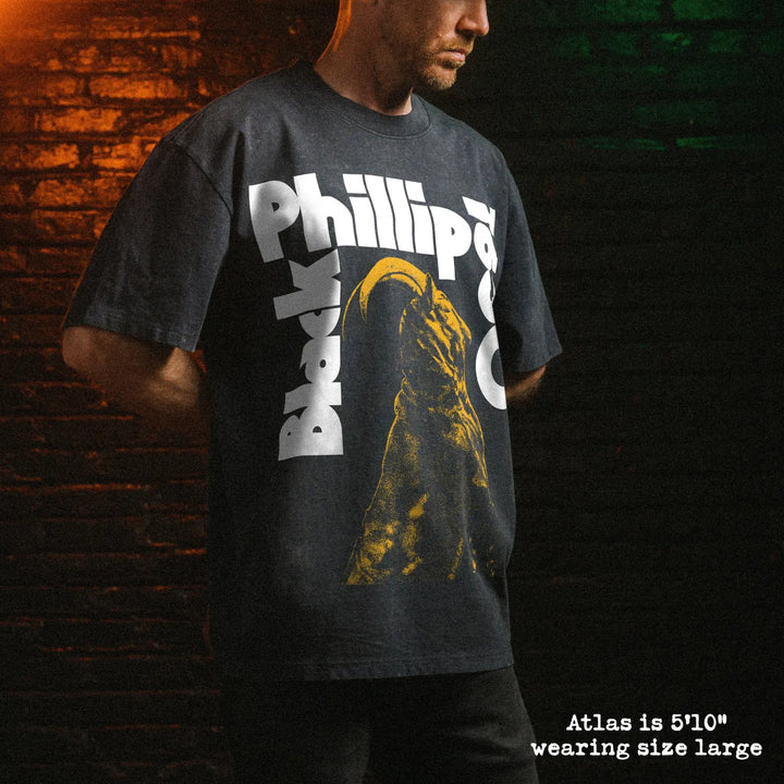 Male model wearing stone washed heavy tee with black phillip graphic 
