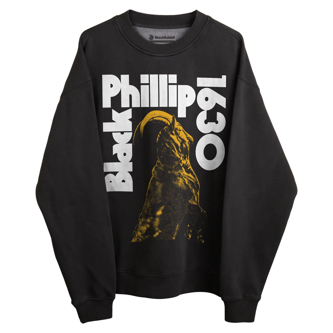 Black sweatshirt with ’black phillip 1630’’ text and yellow witch silhouette design.