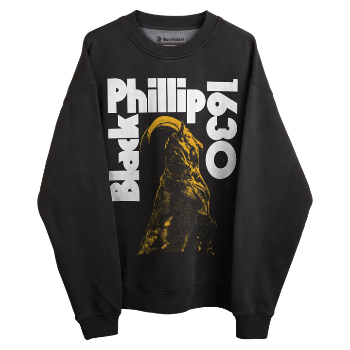 Black sweatshirt with ’black phillip 1630’’ text and yellow witch silhouette design.