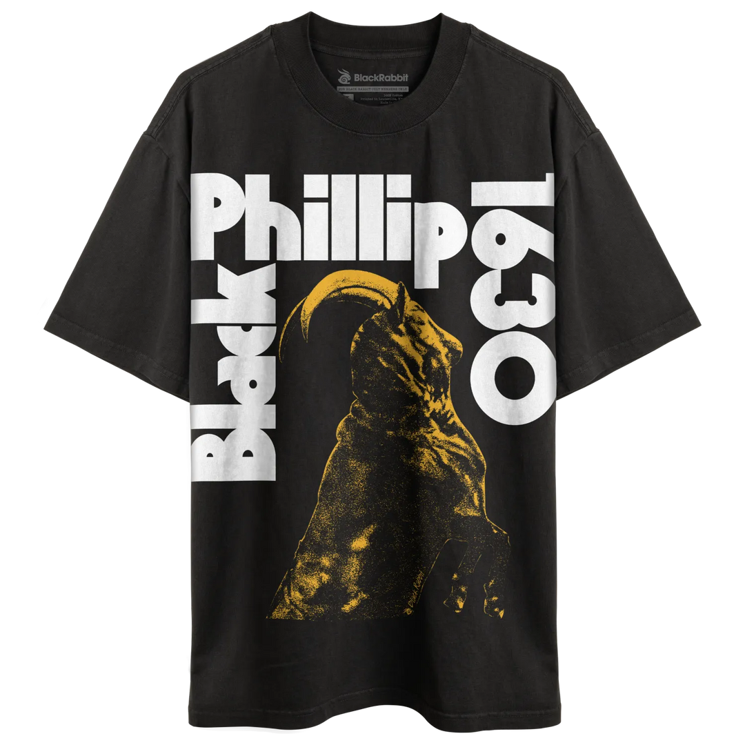 Black t-shirt with a yellow and black graphic of a horned creature and white text.