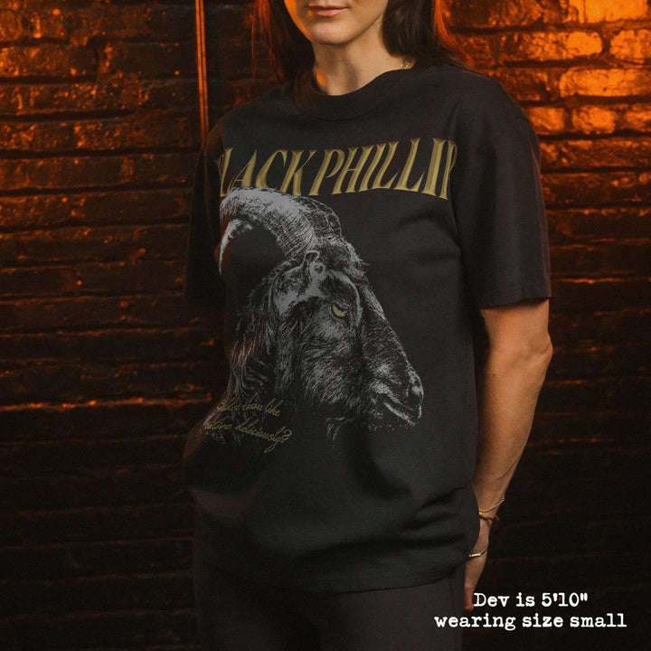 Model wearing faded black heavy tee with black phillip graphic 