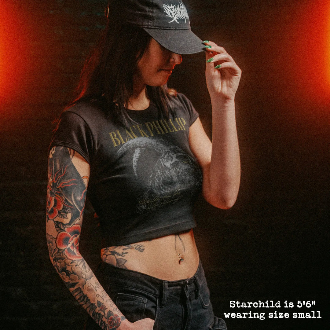 Female model wearing cropped baby tee with black phillip graphic
