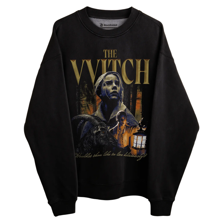 Black sweatshirt with ’the witch’ graphic design featuring a woman and dog, dark background.