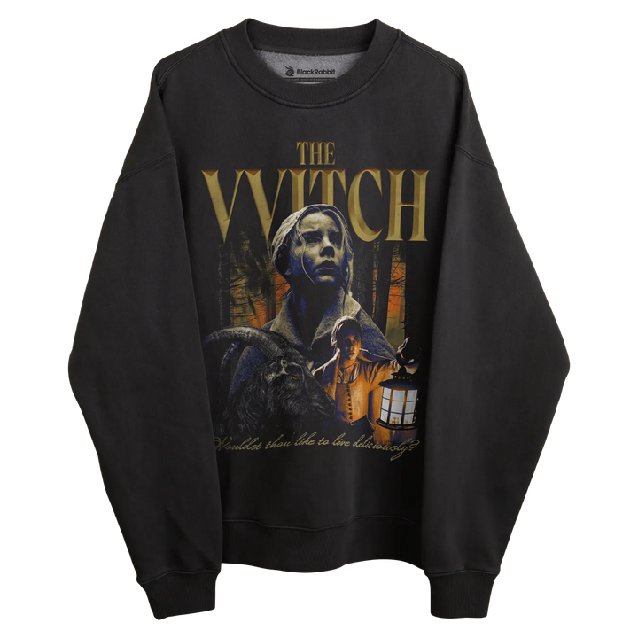 Black sweatshirt with ’the witch’ graphic design featuring a woman and house silhouette, printed on front.