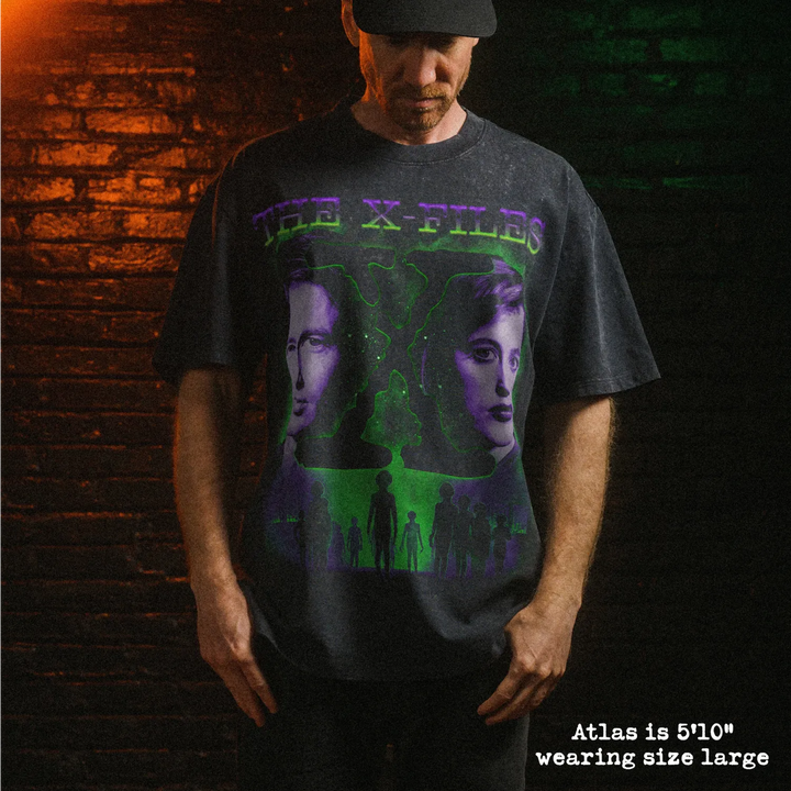 Male model wearing heavy stone washed tee with x files graphic. 