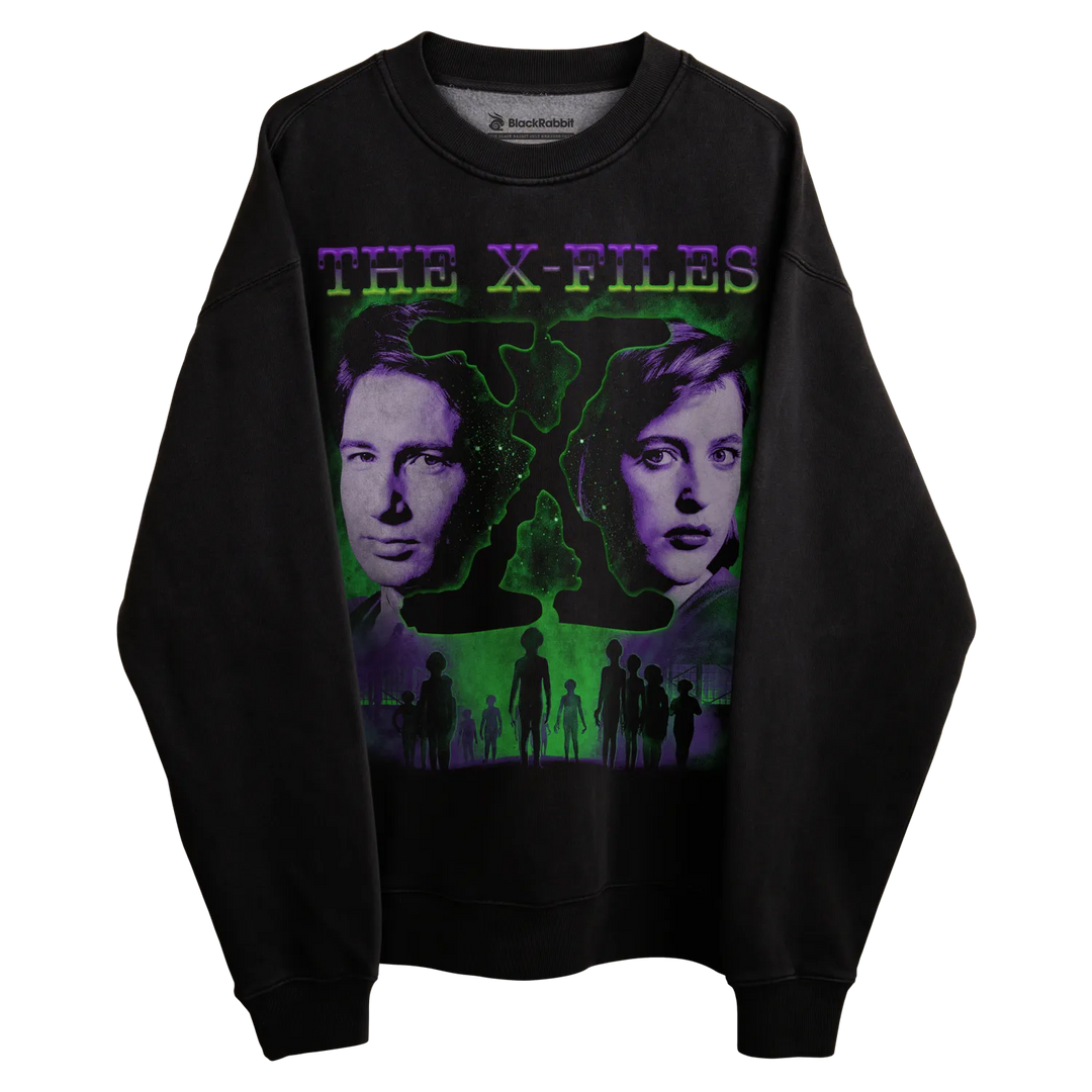 Black crewneck sweatshirt with ’the x-files’ design featuring mulder and scully, ufo silhouette, green glow effect.
