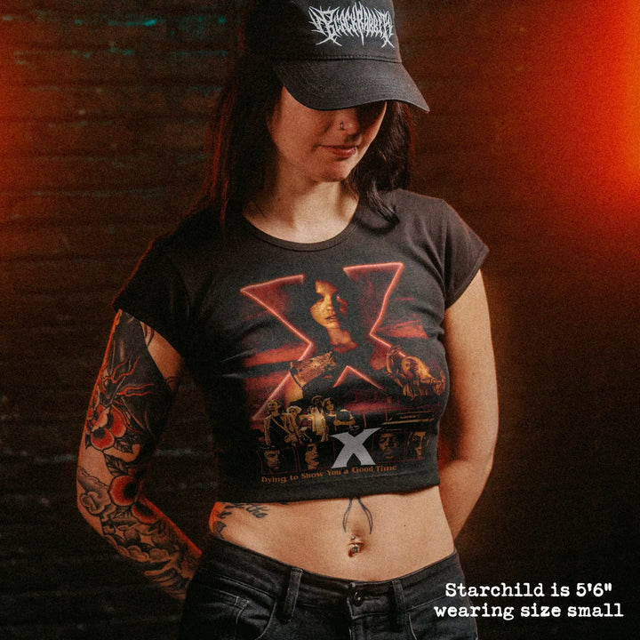Female model wearing cropped baby tee with X graphic
