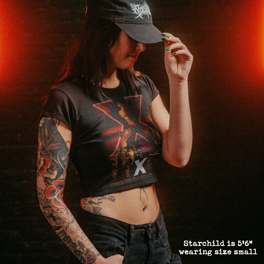 Female model wearing cropped baby tee with X graphic
